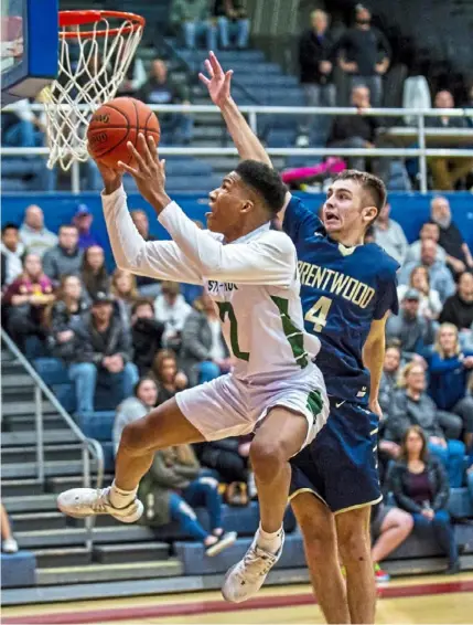 ?? Christian Snyder/Post-Gazette ?? Sto-Rox’s Jamil Williams rises for a layup past Brentwood’s C.J. Ziegler. Williams finished with 15 points.