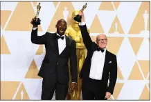  ?? AP/JORDAN STRAUSS ?? Kobe Bryant (left) and Glen Kean hold up the Oscars they won Sunday night for the best animated short film Dear Basketball at the Dolby Theatre in Los Angeles.