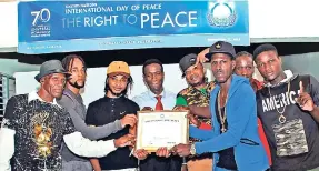  ?? CONTRIBUTE­D ?? Eugene Pitter (left) and the executive of Just for Peace Internatio­nal collect an award from Dennis Salmon (fourth left), president of the Universal Peace Federation, at the Stella Maris Pastoral Centre in Kingston.