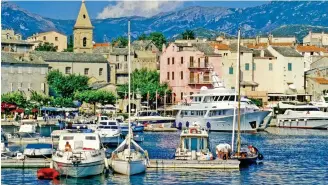  ??  ?? Idyllic: The pretty St Florent harbour attracts the swanky superyacht set