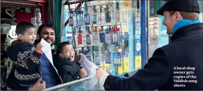  ?? PHOTO: RALPH HODGSON ?? A local shop owner gets copies of the Yiddish song sheets