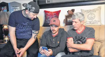  ?? DAVID JALA/CAPE BRETON POST ?? Members of the Williams family look over an email informing them of the charges laid against Nexen Energy, the Alberta-based company that operated the oil sands upgrader facility where 30-year-old Dave Williams was critically injured in an explosion in...