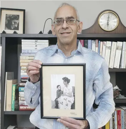  ?? IAN KUCERAK ?? Author Robert Bhatia is seen in his Edmonton home Thursday with a photo of himself as a boy and his mother, author Helen Forrester. Bhatia wrote Passage Across The Mersey, about his mother.