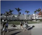  ?? GREGORY BULL — THE ASSOCIATED PRESS ?? People pass the closed Hotel Del Coronado in Coronado on Thursday. The tourism industry is gearing back up with California giving counties the green light to allow hotels, zoos, aquariums, wine tasting rooms and museums to reopen Friday.