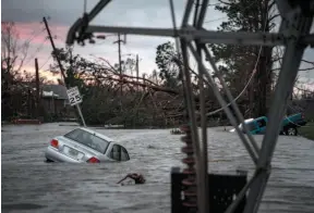  ?? WASHINGTON POST PHOTO BY JABIN BOTSFORD ?? A car is seen caught in flood water in Panama City, Fla., after Hurricane Michael made landfall along the Florida panhandle on Wednesday.