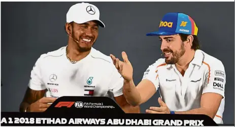  ?? — AFP ?? Enjoying the moment: Fernando Alonso (right) and Lewis Hamilton addressing the press conference ahead of the Abu Dhabi Grand Prix at the Yas Marina circuit on Thursday.