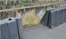  ??  ?? A gaping hole is left in the flood barrier after one of the units was removed.