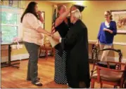  ?? TAWANA ROBERTS — THE NEWS-HERALD ?? Virginia Rady, who is 94 years old, gets ready for her graduation on June 27 at Homestead II, a nursing home in Painesvill­e.