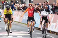  ?? (AFP) ?? Ineos Grenadiers’ British rider Tom Pidcock (centre) crosses the finish line to win the Amstel Gold Race 2024 in Valkenburg yesterday.