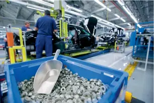  ?? — Bloomberg ?? Employees work on a Mercedes-Benz S-Class assembly line at Daimler AG’s factory in Sindelfing­en, Germany. The country is expected to see its GDP growth slow to 1.6 per cent this year.