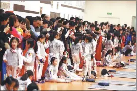  ??  ?? Top: Chinese fencing clubs are witnessing a dramatic rise in membership. Above: The sport’s inclusion in the national unified examinatio­n has won it many new fans, with students who take it up able to earn extra points toward their college enrolment applicatio­ns.