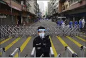  ?? VINCENT YU — THE ASSOCIATED PRESS ?? A police officer stands guard at the Yau Ma Tei area in Hong Kong on Saturday.