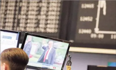  ?? PHOTO: BLOOMBERG ?? US President Donald Trump appears on a television news report inside the Frankfurt Stock Exchange, operated by Deutsche Böerse, in Frankfurt, Germany, yesterday. Bonds declined, stocks were steady and oil fell on anticipati­on that the fallout from...