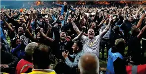  ?? Pictures: GETTY, PA ?? Celebratio­ns...Port Vale fans on the pitch after Thursday’s win over Swindon