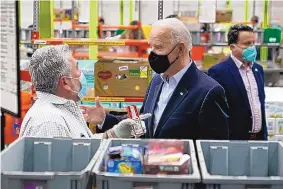  ?? PATRICK SEMANSKY/ASSOCIATED PRESS ?? President Joe Biden talks with a volunteer at the Houston Food Bank on Friday. The president’s first stop was the Harris County Emergency Operations Center in Houston.