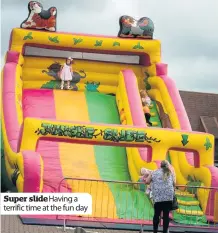  ??  ?? Super slide Having a terrific time at the fun day