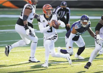  ?? Andy Lyons / Getty Images ?? The Bengals’ Joe Burrow looks to pass against the Titans in a victory Sunday. Though the Bengals ( 251) are barren in so many areas, Burrow looks exactly like a franchise QB.