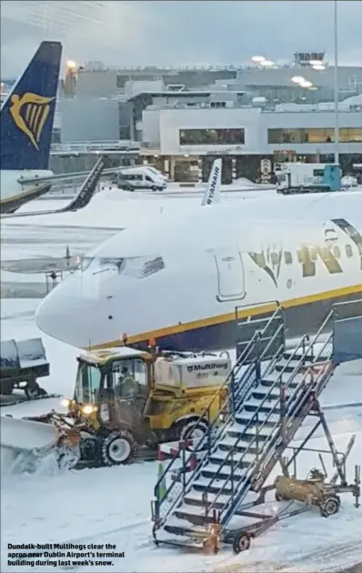  ??  ?? Dundalk-built Multihogs clear the apron near Dublin Airport’s terminal building during last week’s snow.