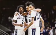  ?? Jessica Hill / Associated Press ?? From left, UConn’s Tristen Newton, Andre Jackson and Jordan Hawkins huddle together in the second half Friday in Storrs.