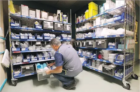  ?? DAN JANISSE ?? An employee sorts through a medical supply area at a Windsor hospital, one of the regional health care facilities that are customers of the TransForm shared service organizati­on. TransForm is projected to grow by 10 to 100 per cent over the next year,...