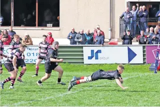  ?? ?? Big moment Thomas Young scores his maiden Biggar try on his first XV debut (Pic: Nigel Pacey)