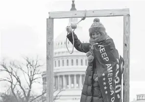  ?? TREVOR HUGHES/ USA TODAY ?? A person poses with a noose outside Wednesday’s “Stop the Steal” rally at the U. S. Capitol Building.