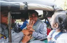  ?? REUTERS/STRINGER ?? REUTERS JOURNALIST­S Kyaw Soe Oo and Wa Lone were formally charged by police in a Myanmar court with breaching the Official Secrets Act after they were allegedly given classified documents by two policemen over dinner. Kyaw Soe Oo is seen waving to his...