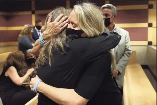  ?? Amy Beth Bennett / Associated Press ?? Gena Hoyer, right, hugs Debbie Hixon during a court recess following Marjory Stoneman Douglas High School shooter Nikolas Cruz's guilty plea on all 17 counts of premeditat­ed murder and 17 counts of attempted murder in the 2018 shootings, at the Broward County Courthouse in Fort Lauderdale, Fla. Hoyer's son, Luke Hoyer, 15, and Hixon's husband, Christophe­r Hixon, 49, were both killed in the massacre.