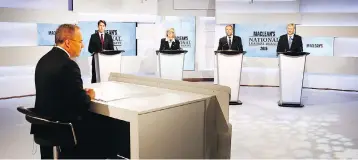  ?? MARK BLINCH / AFP / GETTY IMAGES ?? Liberal Leader Justin Trudeau, from left, Green Party Leader Elizabeth May, former NDP leader Thomas Mulcair and former Conservati­ve leader Stephen Harper square off in August 2015 for a leaders’ debate, moderated by Paul Wells, foreground, of Maclean’s magazine.