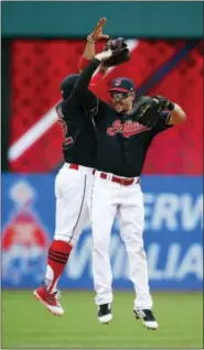  ?? RON SCHWANE - THE ASSOCIATED PRESS ?? Cleveland Indians’ Francisco Lindor, left, and Lonnie Chisenhall celebrate a 5-3 victory over the Detroit Tigers in a baseball game, Wednesday, in Cleveland. The Indians set the American League record with 21 consecutiv­e wins.