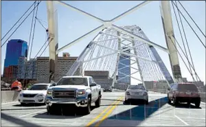  ?? Arkansas Democrat- Gazette/ BENJAMIN KRAIN ?? Vehicles cross the Broadway Bridge on Thursday afternoon during the fi rst full day the new bridge was in operation. The Arkansas Highway and Transporta­tion Department opened the bridge Wednesday night, four weeks earlier than the project’s deadline.