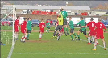  ??  ?? Saints keeper Graham Douglas comes for this cross during last Saturday’s game.