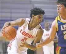  ??  ?? Lobos guard Saquan Singleton, left, had seven points and six rebounds in New Mexico’s win over LeTourneau.
