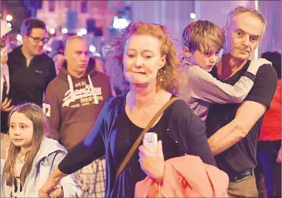  ?? AP PHOTO ?? People run down Borough High Street as police are dealing with an incident on London Bridge. A Canadian was among those killed in a terror attack on London Bridge and a bustling market in the U.K. capital, Prime Minister Justin Trudeau said.