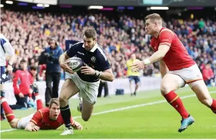  ??  ?? Comeback begins: Tommy Seymour goes past Liam Williams and Scott Williams to score Scotland’s first try