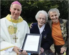  ??  ?? Sr Rita Clare receiving the President’s letter from Bishop Denis Brennan. Also pictured is Sr Miriam Kerrisk.