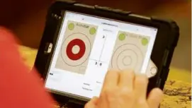  ?? ?? Score was kept on a tablet during an ax league competitio­n. Competitor­s say it’s a sport of finesse and not strength.