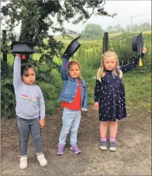  ??  ?? Nursery graduates Naeve McNeill, Arianna Gilchrist and Eilidh Parkhouse preparing to throw their hats in the air.