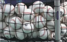  ?? Charlie Riedel / Associated Press 2020 ?? MLB says the baseballs to be used in 2021 should fly a foot or two shorter than those used in 2020 when they are hit at least 375 feet.