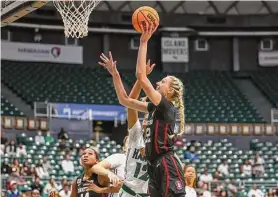  ?? Darryl Oumi/Getty Images ?? Stanford’s Cameron Brink rises above Hawaii’s Imani Perez to put up a shot Sunday. Brink had 15 points and nine rebounds in the Cardinal’s victory.