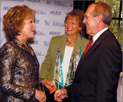  ??  ?? First lady Susan Hutchinson with Janice and Bill Reed of Stuttgart