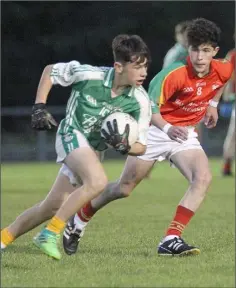  ??  ?? Naomh Eanna’s Kyle Kenny looks to take on Matt Kinnaird of the Starlights in their clash at St Patrick’s Park.