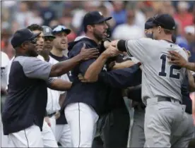  ?? DUANE BURLESON — THE ASSOCIATED PRESS ?? Detroit Tigers hitting coach Lloyd McClendon, left, tries to pull Justin Verlander, center, away from New York Yankees' Chase Headley during the second benchclear­ing of the baseball game, in the seventh inning Thursday in Detroit. The Tigers defeated...