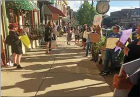  ?? LINDA STEIN — DIGITAL FIRST MEDIA ?? Protesters line the sidewalk outside a fundraiser for Sen. Daylin Leach.