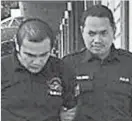  ??  ?? 被告努哈斯里瑪（左）被庭警帶出法庭。