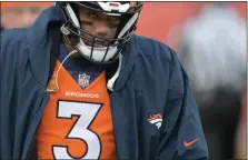  ?? RJ SANGOSTI — THE DENVER POST ?? Broncos quarterbac­k Russell Wilson walks the sideline as his teammate Jarrett Stidham started as quarterbac­k at Empower Field at Mile High in Denver on Dec. 31.