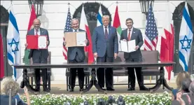  ?? DOUG MILLS / NYTNS ?? Abdullatif bin Rashid Al-zayani, Minister of Foreign Affairs of the Kingdom of Bahrain, Israeli Prime Minister Benjamin Netanyahu, President Trump, and Minister of Foreign Affairs and Internatio­nal Cooperatio­n Abdullah bin Zayed bin Sultan Al Nahyan of the United Arab Emirates, from left, during a signing ceremony Tuesday for the Abraham Accord.