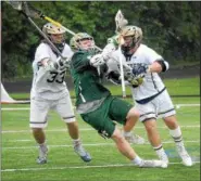  ?? GENE WALSH — DIGITAL FIRST MEDIA ?? La Salle’s Joseph Burnham and Daniel Jordan surround Lansdale Catholic’s Ryan Flanegan during their PCL semifinal Wednesday.