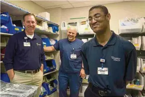  ??  ?? ‘I love my job,’ says Anthony Goodson (right) w ho is responsibl­e for keeping things organised in the emergency room store room at Kennedy Health Systems in New Jersey.