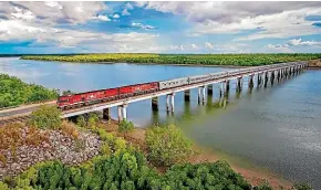  ?? PHOTOS: GREAT SOUTHERN RAIL/SUPPLIED ?? The Ghan crosses the Elizabeth River en route to Katherine.